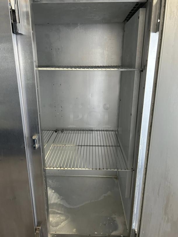 Traulsen G31010 77" solid door reach-in freezer, tested and working, interior view, showing shelving and clean condition.