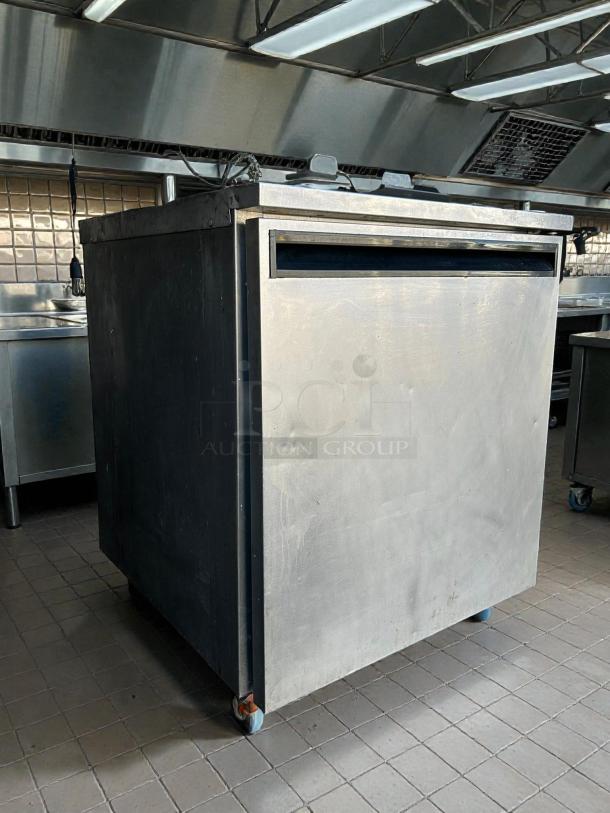 Delfield 407 undercounter refrigerator, 5.7 cu ft, single door, tested and working, shown in stainless steel kitchen setting.