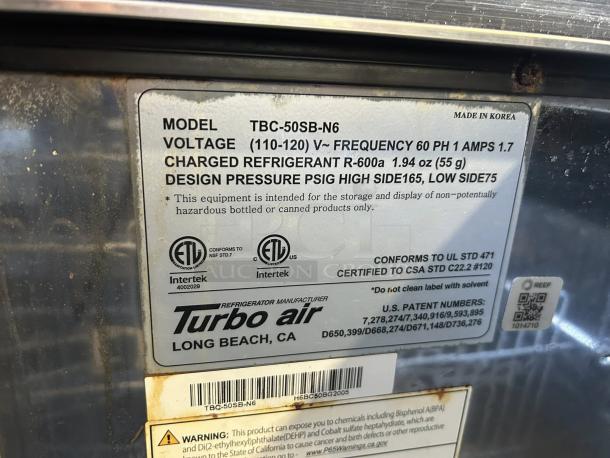 Turbo Air TBC-50SB-N6 label showing model specifications, voltage, refrigerant type, certifications, and warnings.