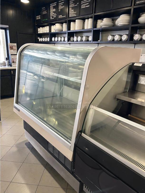 Schmidt 48" curved glass refrigerated bakery display case in great condition. Tested and working, ideal for showcasing products.