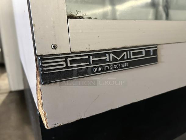 Schmidt 48" curved glass refrigerated bakery display case in great condition with "Quality Since 1870" label.