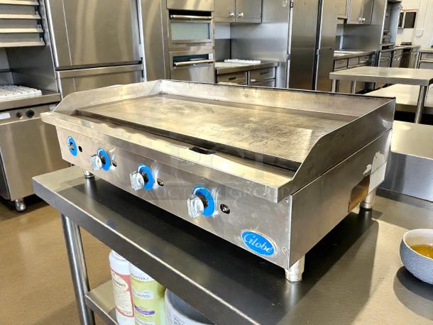 Globe GG48G 48" natural gas griddle with manual controls. Stainless steel, tested, working, minor wear, countertop model.