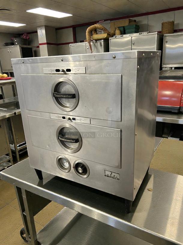 Toastmaster 3B84DT72 food warming drawer unit, excellent condition, free-standing, two drawers, labeled controls visible.