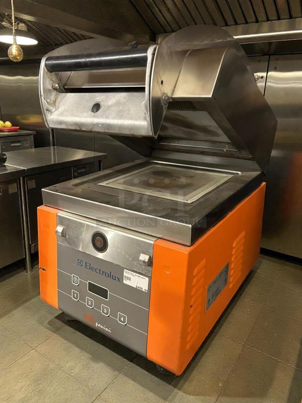 Electrolux 603743 high-speed infrared panini grill, tested, with stainless steel and orange accents, in working condition.