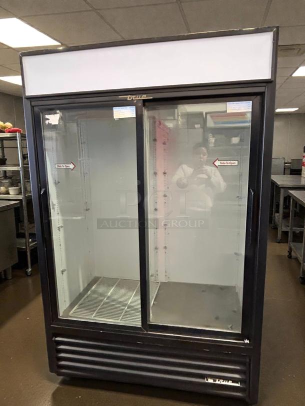 True GDM-45-HC-LD glass door merchandiser, excellent condition, two-section, tested, 51 1/8" width, "Slide to Open" labels.