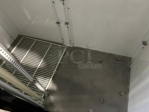 Interior of True GDM-45-HC-LD merchandiser in excellent condition, showing white metal shelving and clean surfaces.