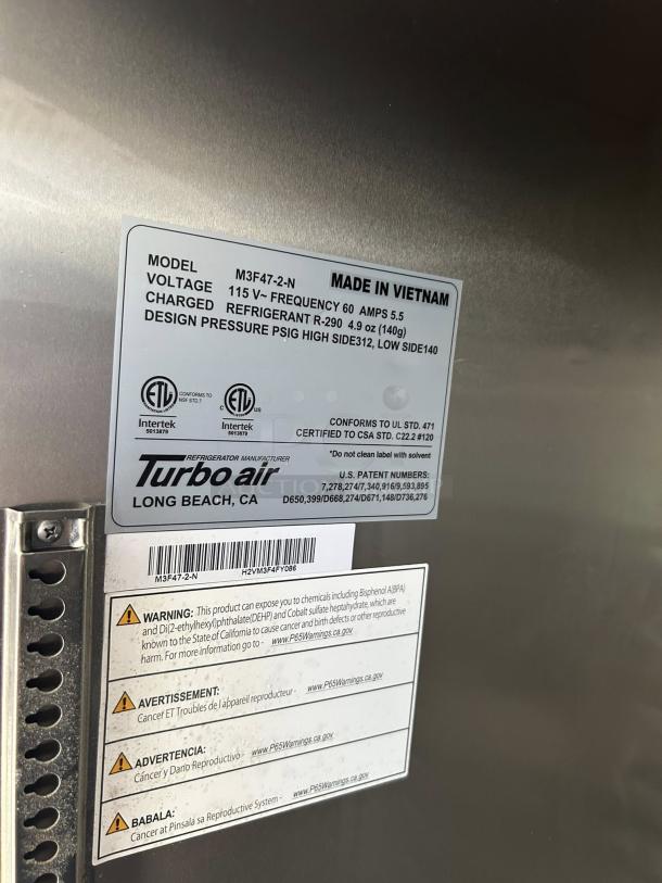 Turbo Air M3F47-2-N stainless steel reach-in freezer label, model info, voltage, refrigerant type, made in Vietnam.