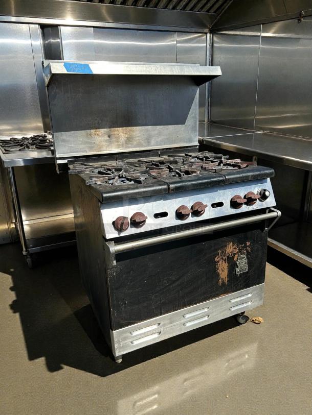 Wolf WX36-6BP 36" gas range with 6 burners, standard oven, great condition, visible signs of use, tested, and working.