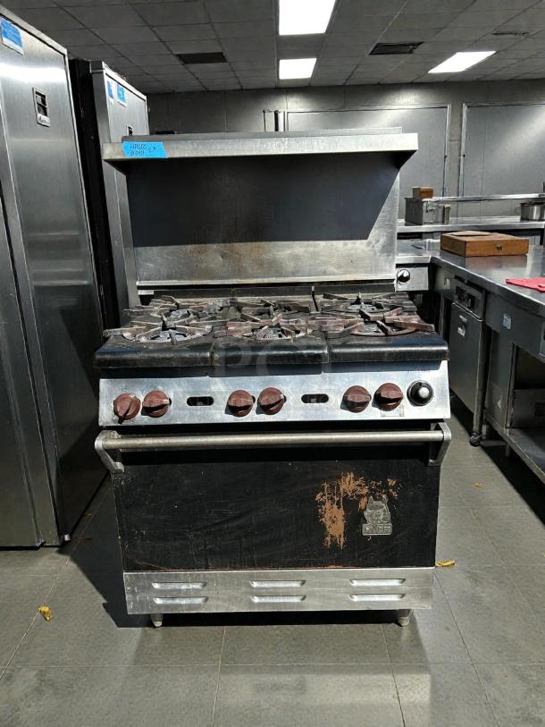 Wolf WX36-6BP 36" gas range with 6 burners and standard oven. Tested and working, good condition, slight wear visible.