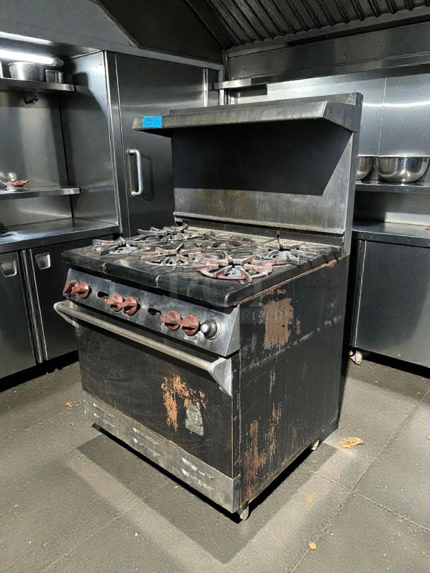 Wolf WX36-6BP 36" gas range with 6 burners and standard oven. Tested, working, visible wear and patina, industrial setting.