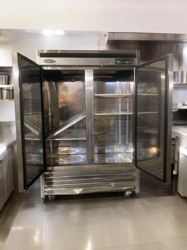 KOOL-IT KBF-2 commercial double door freezer, 115V, in great condition. Features glass doors, adjustable shelves, and casters. Fully tested.