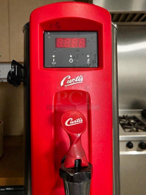 Curtis WB5N low-volume plumbed hot water dispenser, excellent condition, tested and working, red finish, brand logo visible.