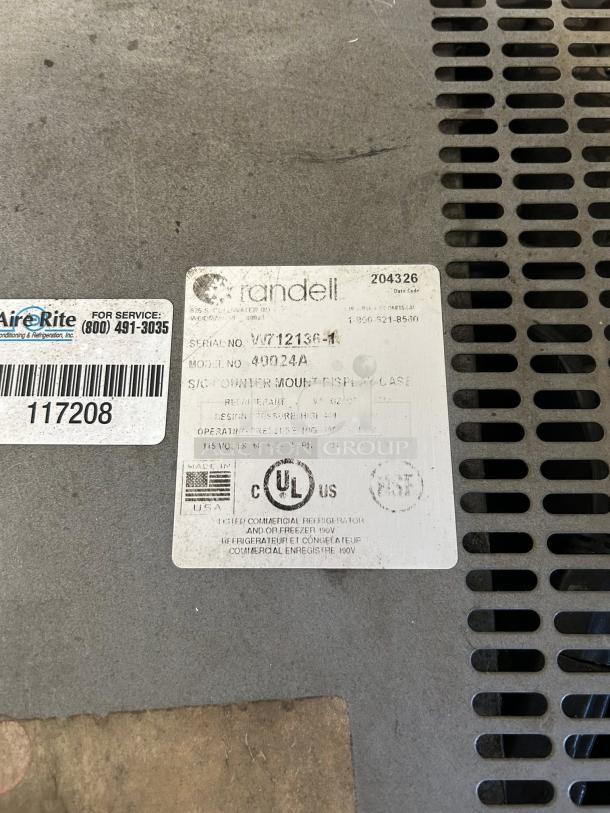 Randell Model W712136-1 Countertop Display Refrigerator label, revealing serial number, model info, and UL certification tag.