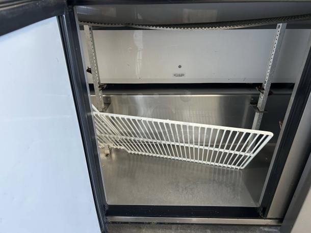 True TSSU-72-18-HC refrigerated sandwich prep table interior, showing shelving and stainless steel surfaces in excellent condition.