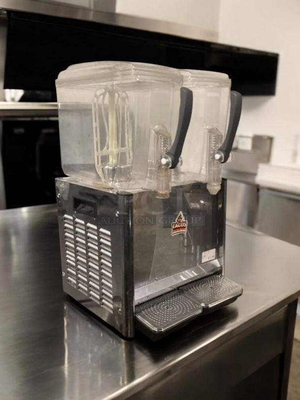 Commercial Grade dual-tank beverage dispenser, 115V AC, prime condition, fully tested, with dispenser handles and clear tanks.