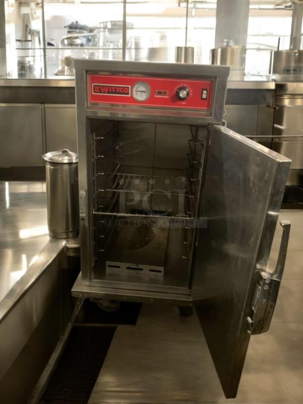 Witco electric warming cabinet in great condition, 120V, tested and working, with control gauge and adjustable shelves.