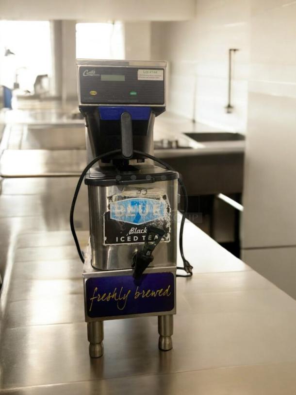 Immaculate Curtis FTT310000 commercial coffee brewer, 120V, fully tested and working. Features iced tea label, sleek stainless steel.