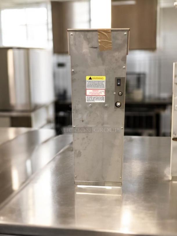 Commercial cold brew dispenser in great condition, fully tested and working. Stainless steel body with visible warning labels.