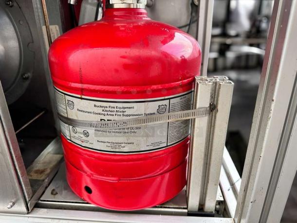 Apace UM1EGA ventless hood system in outstanding condition, featuring a red Buckeye fire suppression cylinder, labeled for kitchen use.