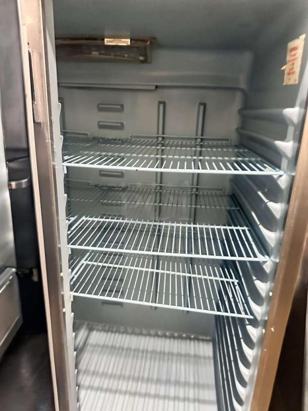 Delfield 6000XL commercial reach-in freezer, prime condition, interior view with multiple wire shelves, tested and working.