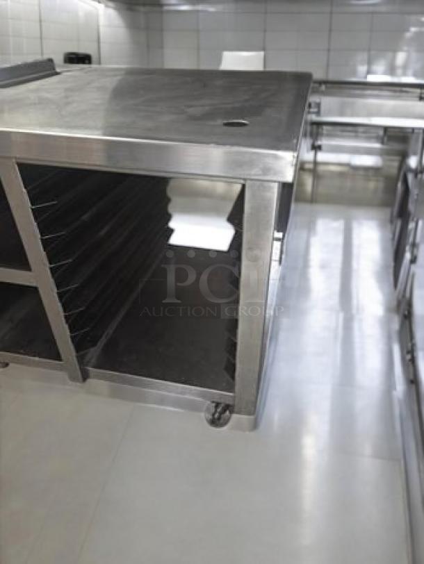 Commercial-grade stainless steel work table with built-in electrical outlets. Ideal for a prep station, superb condition.