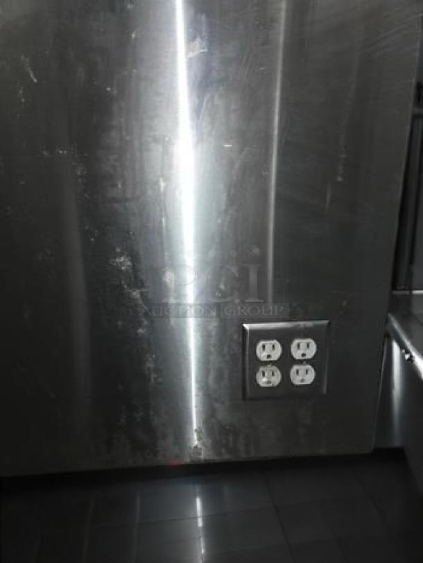 Stainless steel work table with built-in electrical outlets, superb condition, commercial-grade fabrication. Fully tested.