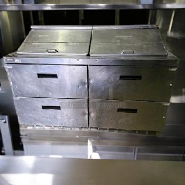 Delfield D4500N-24M refrigerated mega top prep table in outstanding condition; features dual top lids and four storage drawers.