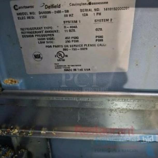 Close-up of Delfield D4500N-24M tag showing model, serial number, and specifications. Made in the USA.