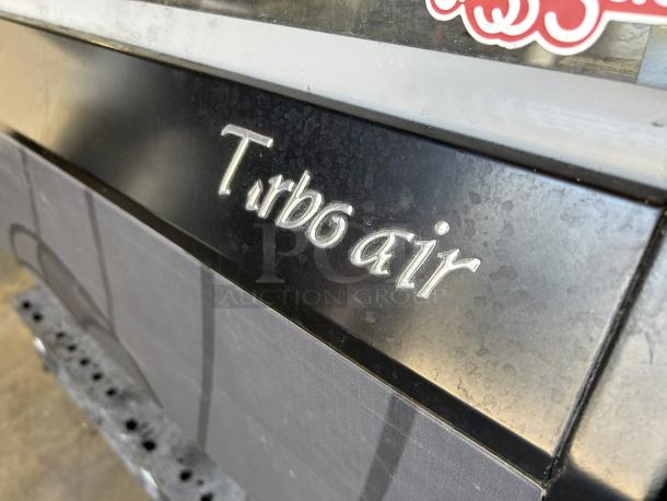 Turbo Air TOM-50LB-N cooler in excellent condition, 50" horizontal open air model, tested and working, showing logo detail.
