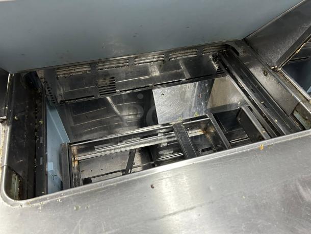 Delfield D4448NP-12 48" sandwich prep refrigerator inside view, showcasing metal interior.