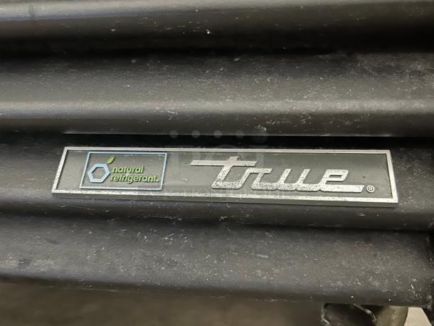 True GDM-23-HC~TSL01 merchandiser label, highlighting natural refrigerant feature on a black glass door unit in great condition.