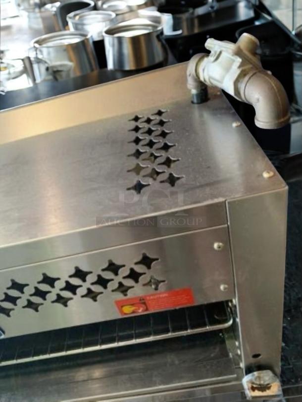 Radiance TACM-36 gas cheese melter in outstanding condition, featuring a 36" stainless steel body and decorative vent holes.