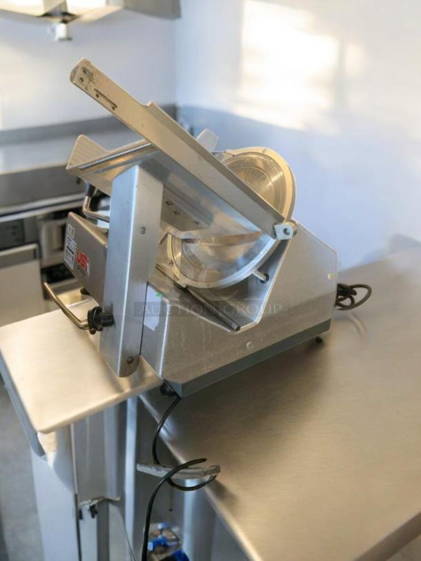 Bizerba GSP HD meat slicer in prime condition, 120V, fully tested, stainless steel, model T-11, on kitchen counter.