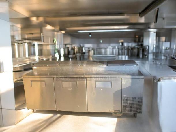 True TPP-93 pizza prep table in impressive condition; three-door stainless steel unit, fully tested and functional, 115V.