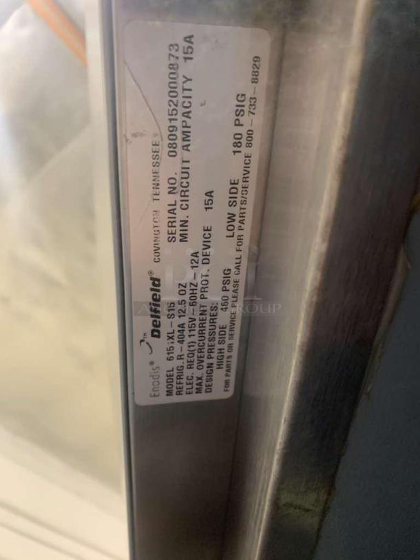 Alt text: Delfield 615XL-S15 label showing model, serial number, electrical specs, and pressure ratings for commercial refrigerator.