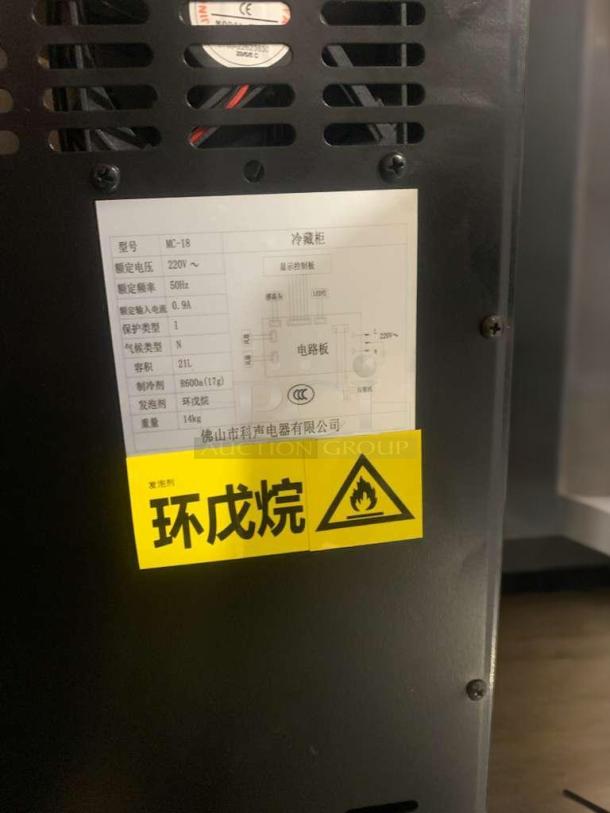 Prime condition Foshan MC-18 mini cooler, black, 220V, fully tested. Features warning label and detailed specification panel.