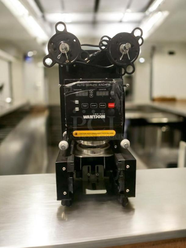 WANTJOIN WZ-95B Automatic Cup Sealing Machine in prime condition, 110–120V, fully tested, black exterior, visible controls.