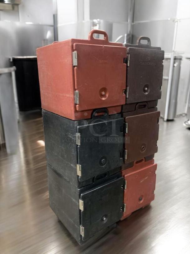 Prime Condition Cambro UPC Series insulated food carriers stacked, red and black, fully operational, ideal for hot/cold transport.