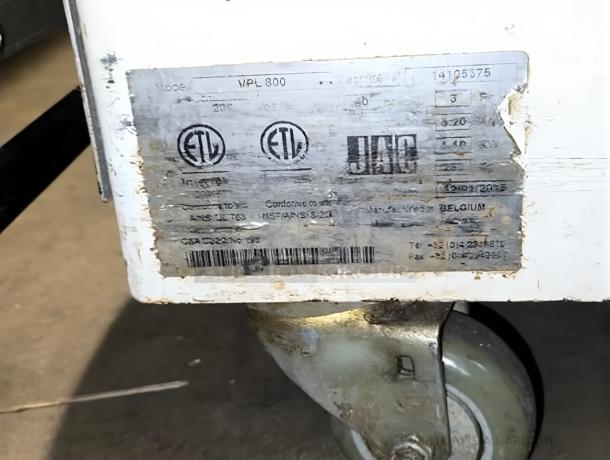 JAC Varia Pro MPL800 bread slicer label showing model details and certifications; on a wheeled base, fully functional.