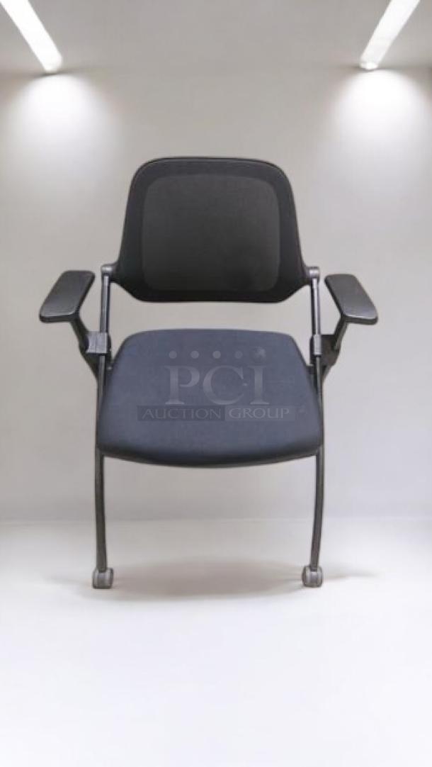 Stackable mesh office chair in premium condition, features armrests and caster wheels. Fully tested and ready for use.
