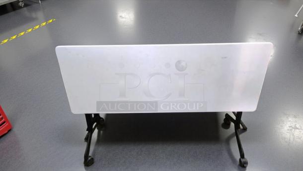 Flip-top training/conference table in prime condition, features locking casters. Fully functional, ideal for versatile setups.
