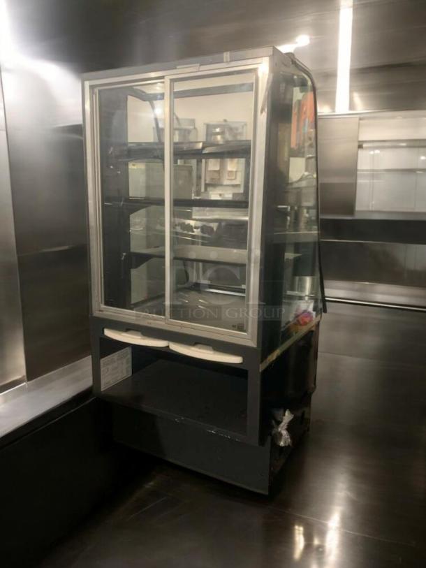 Refrigerated bakery/deli display case with curved glass, multi-shelf design. Superior condition, fully tested and operational.