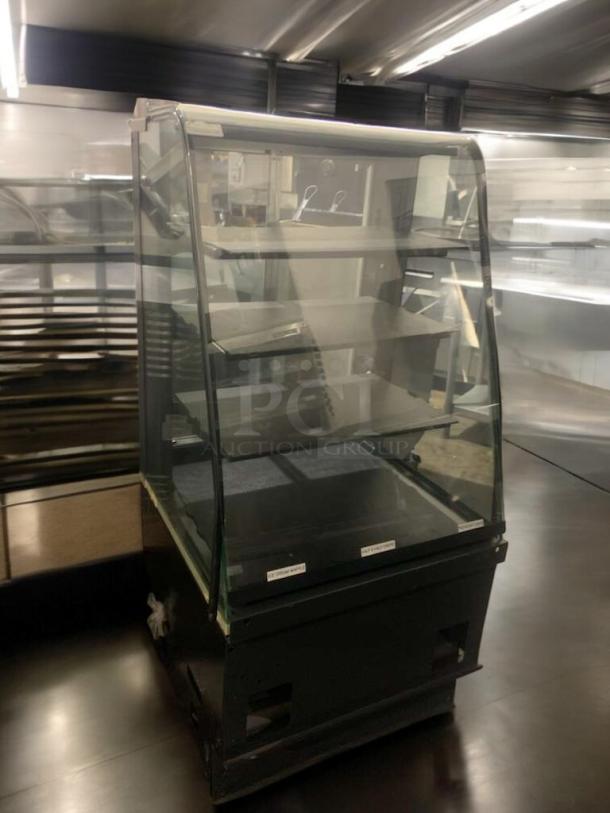 Superior condition refrigerated bakery/deli display case with curved glass, multi-shelf, fully tested and operational.