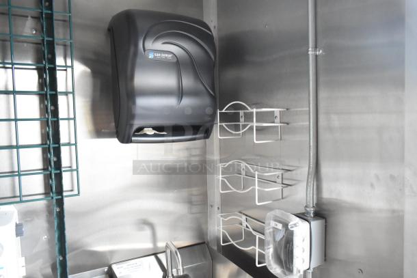 Interior of a 2021 Cruising Kitchens 24' Burger King trailer, featuring a San Jamar paper towel dispenser, wire racks, and stainless steel surfaces.