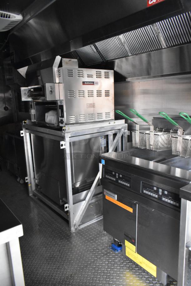 Cruising Kitchens 2021 fast food trailer interior, featuring BroilVection ovens, grease hood, Frymaster fryer, and True freezers.