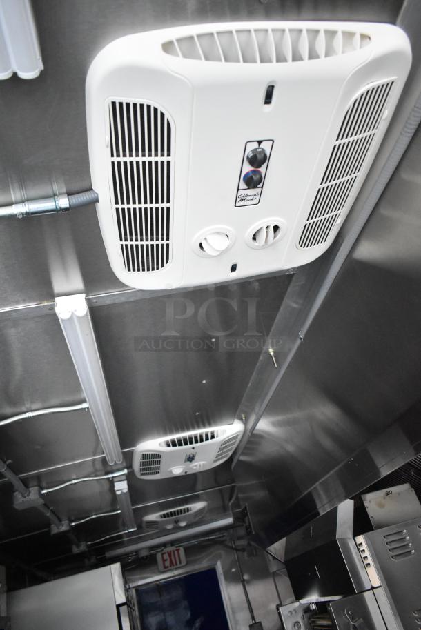 Brand new 2021 Cruising Kitchens 24' fast food trailer interior showing ceiling vent systems and stainless steel setup.