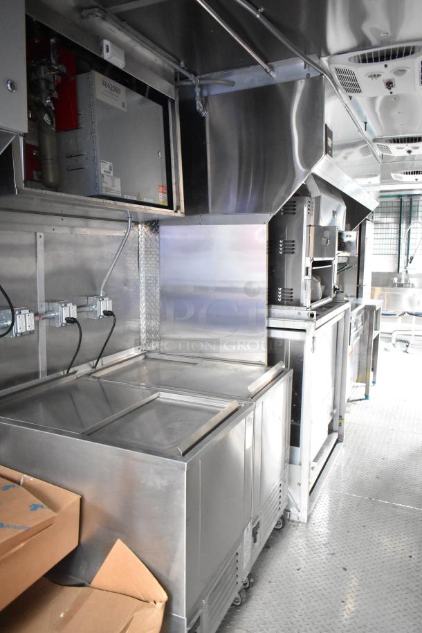 2021 Cruising Kitchens 24' food trailer interior with stainless steel commercial-grade equipment and appliances.