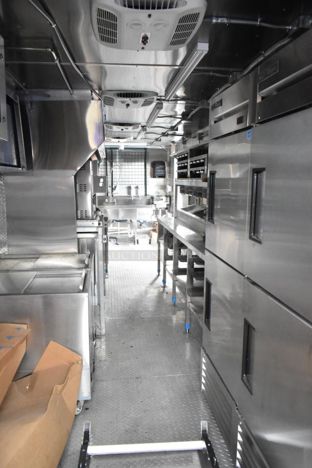 Brand new 2021 Cruising Kitchens 24' mobile kitchen trailer with commercial equipment, including grease hood and fryers.