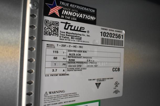 True refrigeration label showing model T-23F-2-HC-MC, serial 10202561, compressor NLE8.8CN, refrigerant R290. Made by True Manufacturing Co.