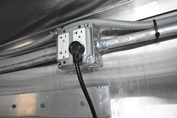 Inside view of a 2021 Cruising Kitchens Burger King mobile kitchen, featuring a GFCI electrical outlet and industrial wiring.